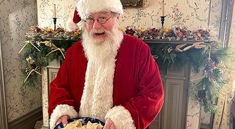 Santa holding cookies at the Black Creek Pioneer Village
