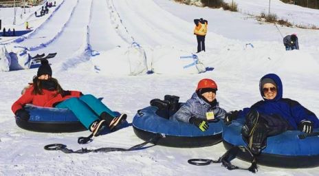A family snow tubing at Chicopee Tube Park