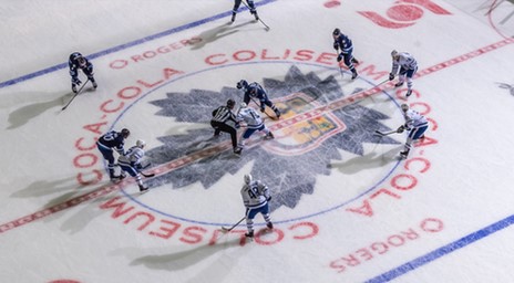 Marlies players facing off at centre ice