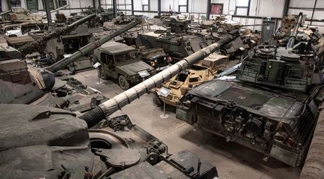 Military tanks and vehicles displayed in a museum