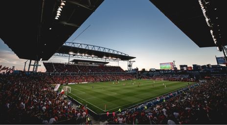 Fans cheering on the Reds at a TFC game at BMO Field